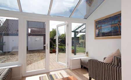 White PVCU Garden Room with garden view from French Doors