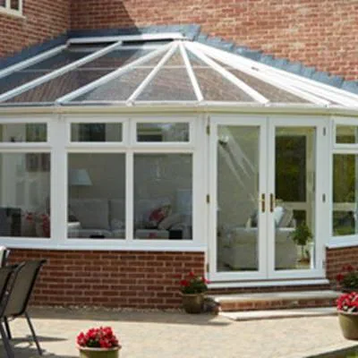 UPVC Victorian corner conservatory finished in white on contemporary home from the Anglian classic conservatory range
