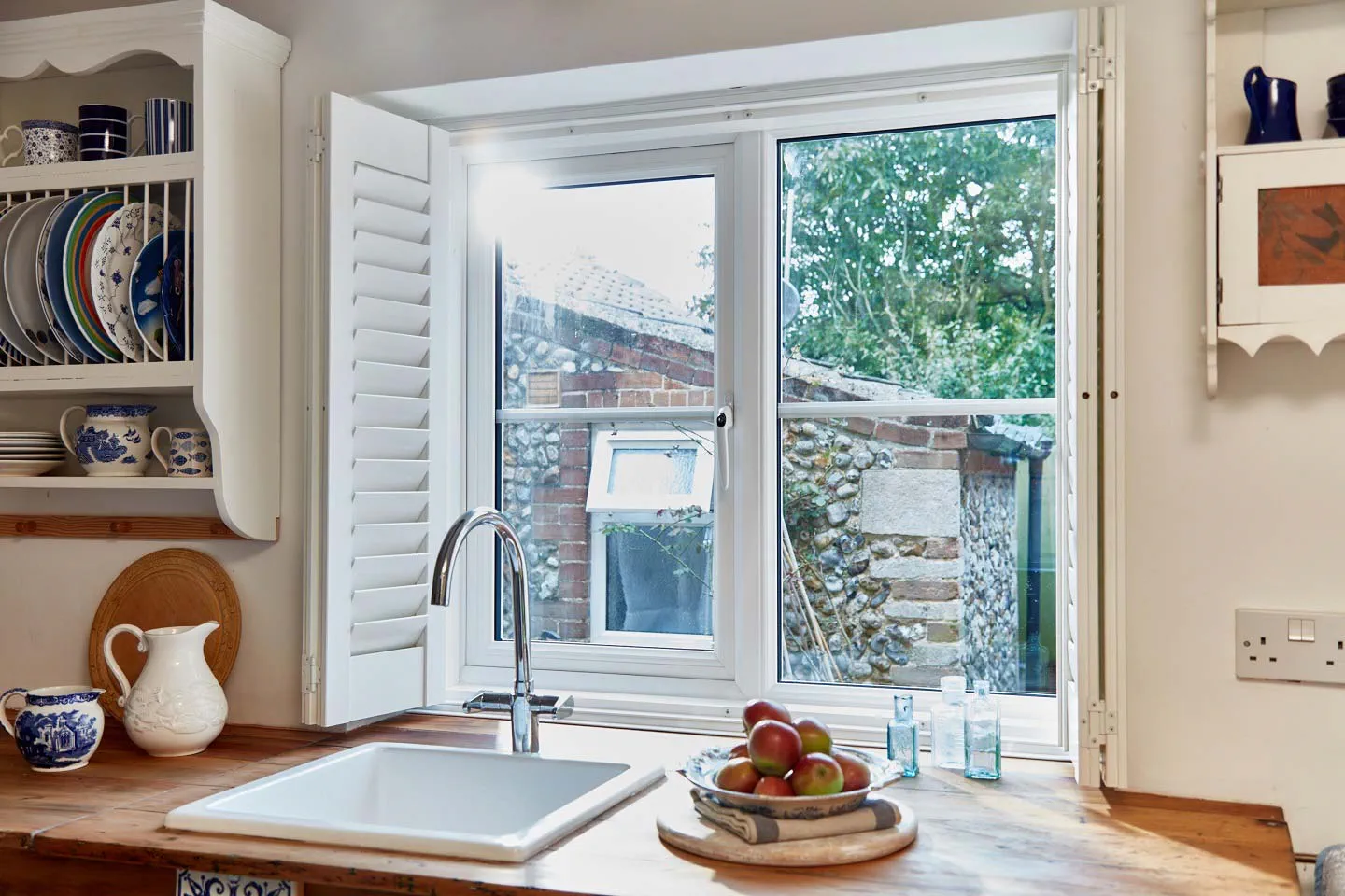 White uPVC kitchen window with wooden blinds design inspiration from Anglian Home Improvements