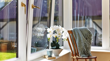 Product tile for tilt and turn windows with gold window handles from Anglian Home Improvements