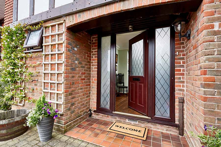 Dark woodgrain composite door with etched glass panels