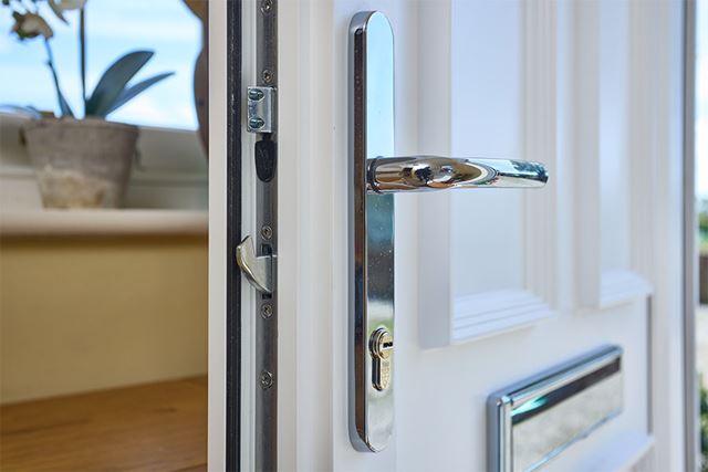 White uPVC front door handle and lock close up