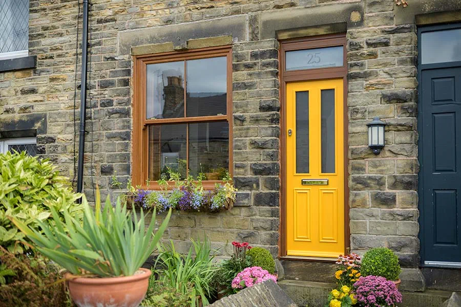 Buttercup wooden front door with dark woodgrain windows